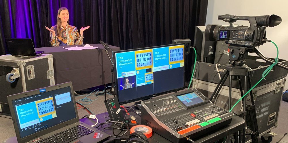 An event production desk set up, with a lady standing in front of it.
